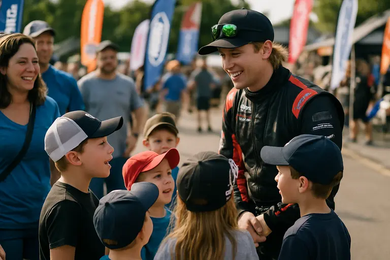 Families and crew members gathered near a race trailer after an event