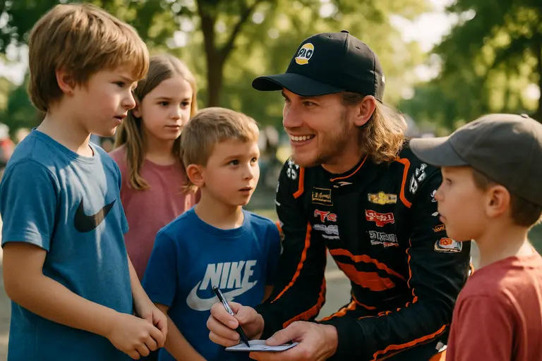 Young racer speaking with crew members near a car at the track